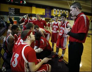 Jefrey Groves, left, watches his brother, Zackarie, sign the instructions from a Bowling Green High School coach during a timeout.