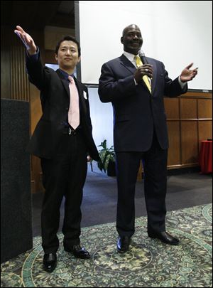 Dashing Pacific Group representative Jimmy Wu and Mayor Mike Bell speak at the Toledo Club in October, 2011. Mr. Wu, the son of investor Wu Kin Hung, has purchased a home in Perrysburg.