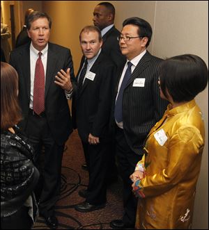 Gov. John Kasich, left, met in March with two figures involved in helping Mayor Bell make connections in China: Scott Prephan, center, and Simon Guo, second from right. Investor Yuan Xiaohong is at right. 