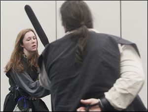 Amanda Person, left, an Eastern Michigan University student from Tecumseh, Mich., fights Gabriel Russell of Toledo in a Dagorhir Battle Game at the University of Toledo's 27th annual BASHCon event. 