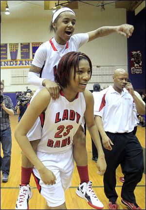 Cha'Ron Sweeney, who scored a game-high 31 points, gets a lift from Ce'Dra Evans after Rogers captured the first City League girls basketball championship in school history.
