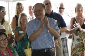 Dashing Pacific Group’s Wu Kin Hung is introduced to the public during a ceremony at the Marina District in July, 2011. The company bought The Docks complex and more than half of the Marina District from the city of Toledo.
