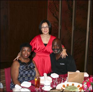 Ora Bell (left), Yuan Yuan Xiaohong center, and Mike Bell at dinner after arriving in Shenzhen, China.