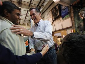 Republican presidential candidate Mitt Romney greets employees at Meridian Bioscience in Cincinnati. He cited the company's owner Monday for taking a risk in founding the firm and then leading its growth. 