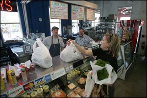 Susan Eskin shops at The Fish Guys store inside North Market, a more successful version of the Erie Street Market in Toledo.