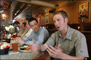 Tim Morgan of Washington, left, listens as Wes Meermans lists the finer points of his Columbus neighborhoods: German Village, where he resides, and Short North, where he goes to play