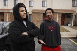 Toledo teens Johny Smith, 16, left, and Lequan Gephart, 15, talk about guns. The teens were visiting friends in an apartment complex where a young boy apparently found a gun and took it to daycare.