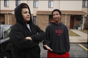 Toledo teens Johny Smith, 16, left, and Lequan Gephart, 15, talk about guns. The teens were visiting friends in an apartment complex where a young boy apparently found a gun and took it to daycare.