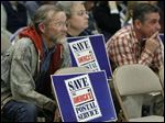  Richard Brust, Toledo postal worker, listens during The U.S. Postal Service's public meeting in December to explain why it wants to move mail processing out of the downtown Toledo facility. 