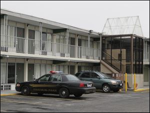 A perrsyburg Police cruiser parked at the Econolodge in Perrysburg where two people were found dead.