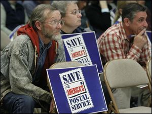 Richard Brust, Toledo postal worker, listens during The U.S. Postal Service's public meeting in December to explain why it wants to move mail processing out of the downtown Toledo facility. 