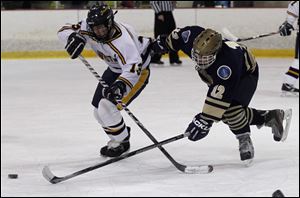 Austin Kelly, right, battles Whitmer’s Damian Brown. Kelly leads the Titans with 30 goals.