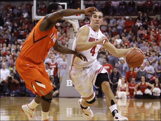 Ohio State's Aaron Craft, right, dribbles past Illinois' D.J. Richardson during the second half of an NCAA college basketball game, Tuesday,.