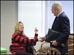  Linda Schwartz and her cousin Albert Ward of Timberlake, Ohio, shake hands. The case over ultimate ownership continues. The items will be encased in glass and stay with Mrs. Schwartz's attorney.