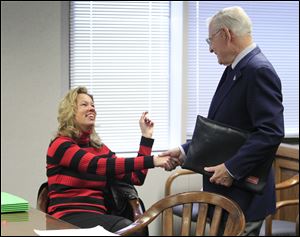 Linda Schwartz and her cousin Albert Ward of Timberlake, Ohio, shake hands. The case over ultimate ownership continues. The items will be encased in glass and stay with Mrs. Schwartz's attorney.