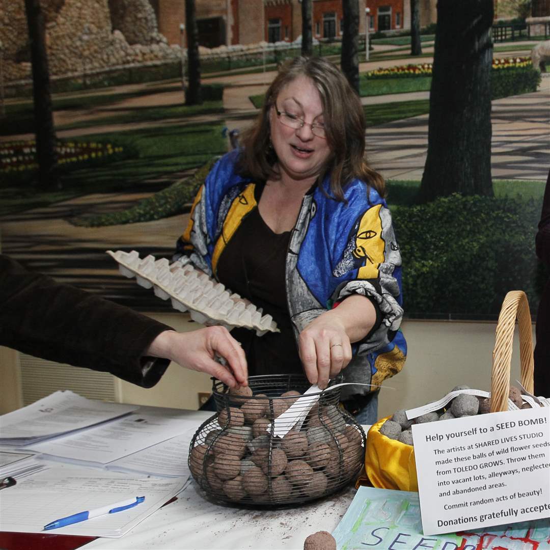 Kelly-Savino-with-a-basket-of-seed-bombs-clay-soil-and-wild-flower-seeds-created-by-the-artists-at-Shared-Lives