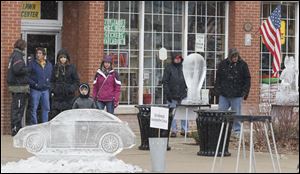 People browse the ice sculptures that line Louisiana Avenue during the WinterFest event. Along with the pieces from the competition, businesses commissioned dozens of other sculptures.