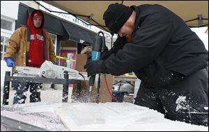 Professional ice sculptor Brian Edwards of Columbus drills away at his ‘Defender of the Faith.’ He placed fifth out of five money winners, earning $125. This was his second time carving the piece.