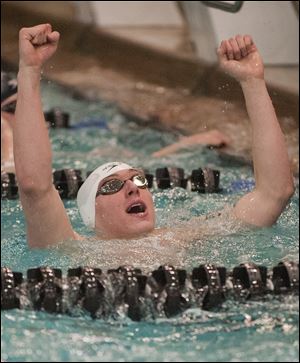 Dan DiSalle of St. Francis celebrates after winning the 50-yard freestyle at the Division I state swimming meet in Canton. DiSalle also captured the 100 free championship, helping the Knights to a third-place finish.