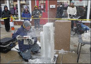 the blade/jeremy wadsworthProfessional ice sculptor Stephan Koch of Yorktown, Ind., cuts into the ice with a chain saw at the carving competition at WinterFest in Perrysburg. First place in Saturday's contest, and $1,200, went to Dan Rebholz of Chicago.