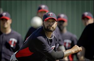 Minnesota Twins relief pitcher Joel Zumaya throws a pitch during a baseball spring training workout Friday in Fort Myers, Fla.