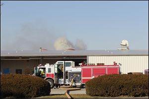The Maumee Fire Dept. responds to smoke which appears to be behind warehouse 6 at The Andersons on Illinois Sunday.