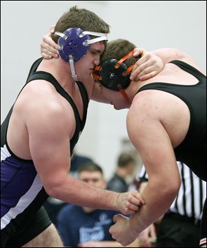 Mimmo Lytle, left, of Swanton battles Justin Gillen of Liberty Center at the Division III wrestling district at Owens CC. Lytle, a defending state champ, won 2-1 in the 285- final.