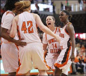 BGSU's Danielle Havel (42) is congratulated by Jessica Slagle (14) and Jasmine Matthews, right, after scoring and drawing a foul. 
