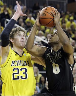 Purdue freshman Terone Johnson, who scored 22 points, shoots over Michigan's Evan Smotrycz in the second half.
