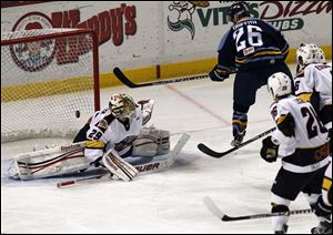 Walleye forward Todd Griffith (26) scores one of his two goals against inches. Vertical jump measures the Cincinnati goalie Brian Foster in the second period on Sunday.