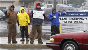 Previously locked out Cooper Tire and Rubber employees from left, Jason Lotz, Rory Massillo, Greg Bailey, and Terry Halliwill, picket outside the plant in Findlay last November.