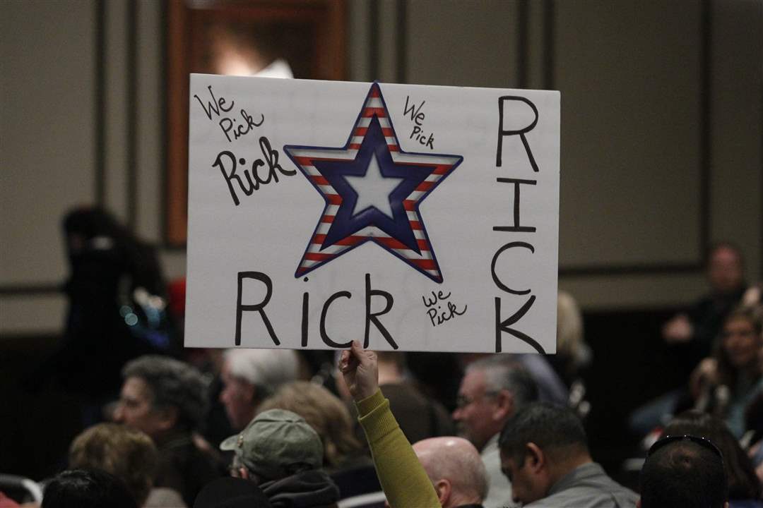 A-supporter-holds-a-sign-as-Republican-presidential-candidate-Rick-Santorum-speaks