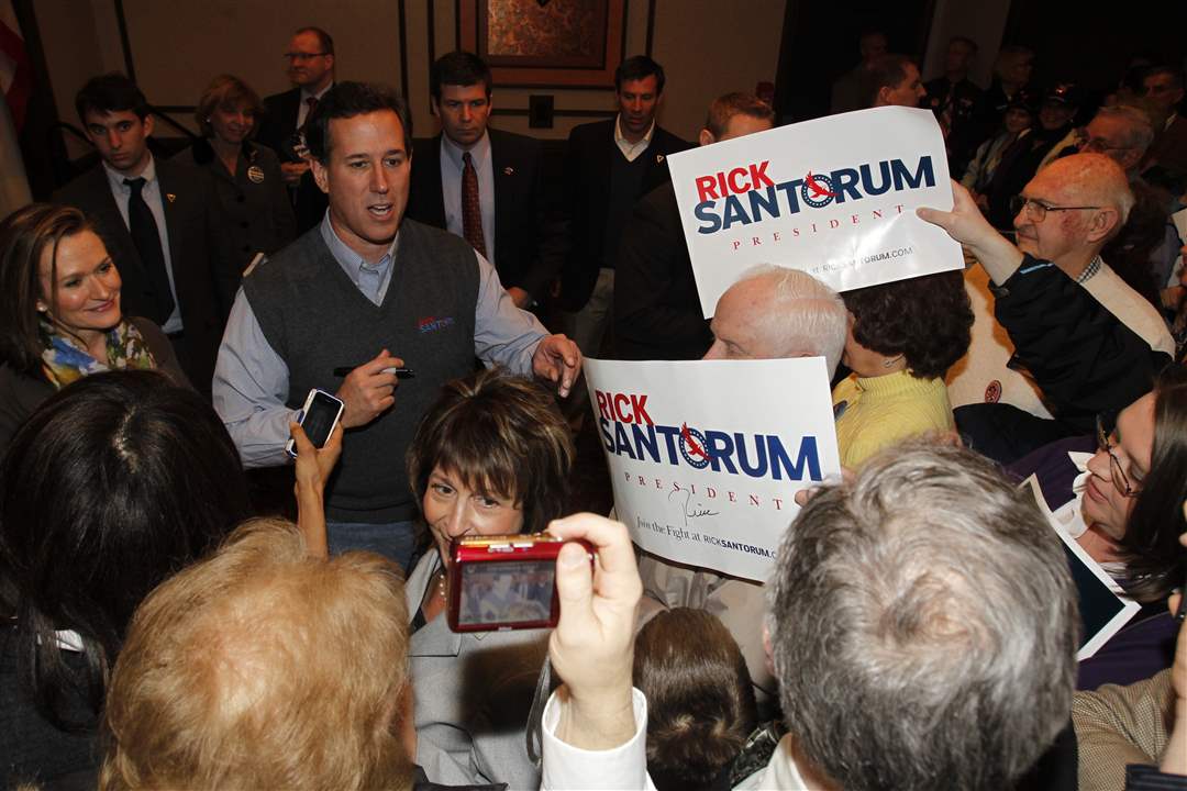 Republican-presidential-candidate-Rick-Santorum-with-wife-Karen-signs-autographs