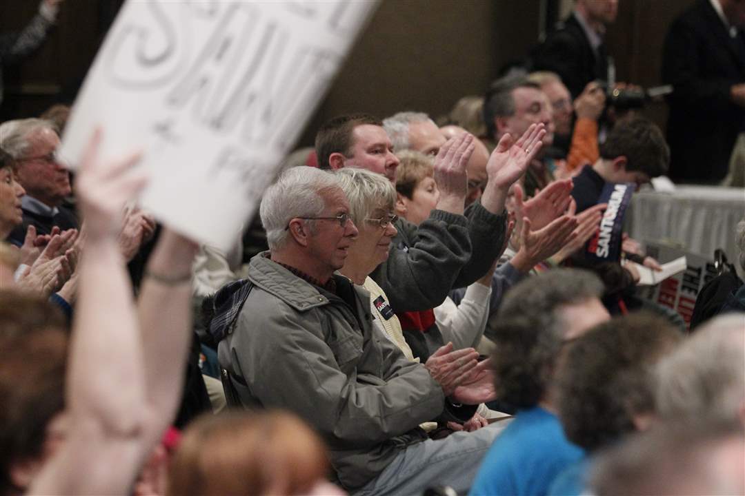 Supporters-applaud-Republican-presidential-candidate-Rick-Santorum-as-he-speaks