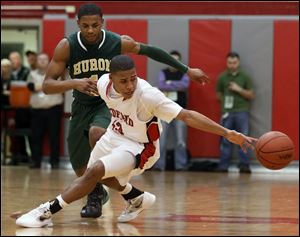 Bedford's Kenneth McFadden, front, steals the ball from Ann Arbor Huron's Andre Bond on Tuesday, in Temperance, Michigan.