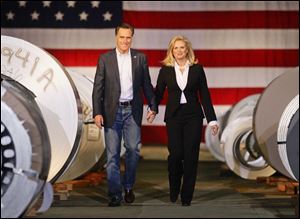 GOP presidential candidate Mitt Romney and wife Ann walk through steel coils at American Posts during a campaign stop Wednesday in Toledo.