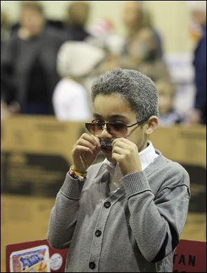 Jaydin Deland adjusts the mustache that is helping him get into character as comic-book creator Stan Lee. Among other famous people at the event were Helen Keller and Johnny Cash.