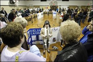 Third grader Rachel Hefner wears a helmet, goggles, and a long scarf as she portrays aviator Amelia Earhart at Toth Elementary School. She was one of 75 participating in the annual museum re-creation.