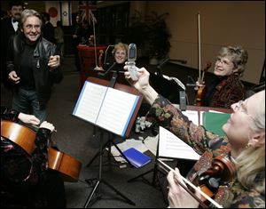 Davy Jones interacts with the Paragon String Quartet during the Toledo Auto Show Gala at the Seagate Center.