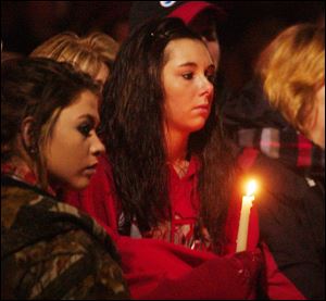 Mourners gather outside St. Mary's Church on Tuesday during a memorial service for three students killed Monday at Chardon High School, in Chardon, Ohio.