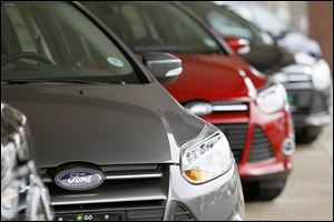 A line of 2012 Focus cars are for sale at a Ford dealership in the south Denver suburb of Littleton, Colo. 