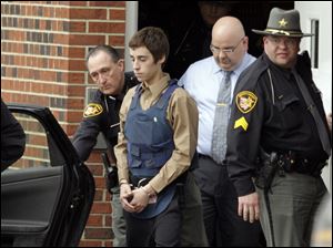 Seventeen-year-old T.J. Lane is led from Juvenile Court by Sheriff's deputies in Chardon, Ohio, after his arraignment in the shooting of five high school students Monday.