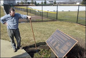 Groundskeeper Tom Sommers gives some attention to the memorial area at the Bluffton University ball field in preparation for the fifth anniversary of the Atlanta bus crash.