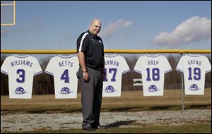 Cutouts representing the jerseys of the five Bluffton University baseball players who were killed in the bus crash provide a backdrop for baseball coach James Grandey, who also was injured in the crash.