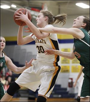 Northview's Miriam Justinger gets past Central Catholic's Michelle Murnen in the third quarter of the Wildcats' district semifinal victory. Justinger led the Wildcats with 19 points. 