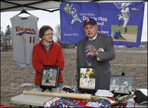Memorabilia of David Betts provide a setting for David’s parents, Joy and John Betts, as Mr. Betts gives details before the groundbreaking of a new indoor baseball/softball venue in Bryan.