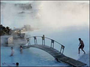 Visitors to Iceland's Blue Lagoon swim in pools of milky-blue, 99-degree geothermal waters.