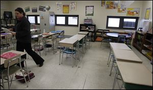 Amanda Kinison, a fourth-grade teacher at Woodmore Elementary School, says cracks in the floor of her classroom have resulted in students tripping and falling. The school was built in 1923.