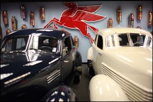Michael Dezer also displays vintage cars, including a 1940 Graham Hollywood, left, and a 1937 Cord 812 Beverly, as well as European classics, bikes, motorcycles, electric cars, micro cars, and military vehicles. He plans a wax museum and a drive-in theater.
