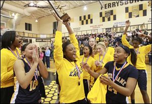 Notre Dame's Talajha Parker raises the girls Division I district basketball championship trophy after the Eagles beat Northviewgame at Perrysburg High School, Saturday.